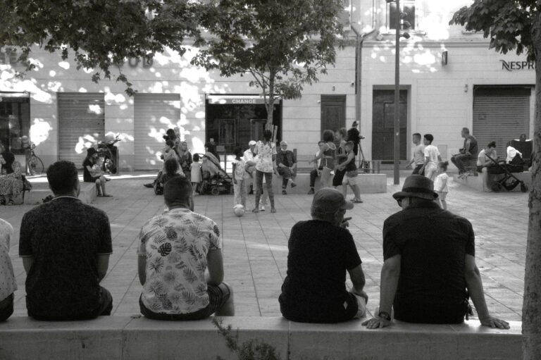 People sitting in a square in Marseille chatting
